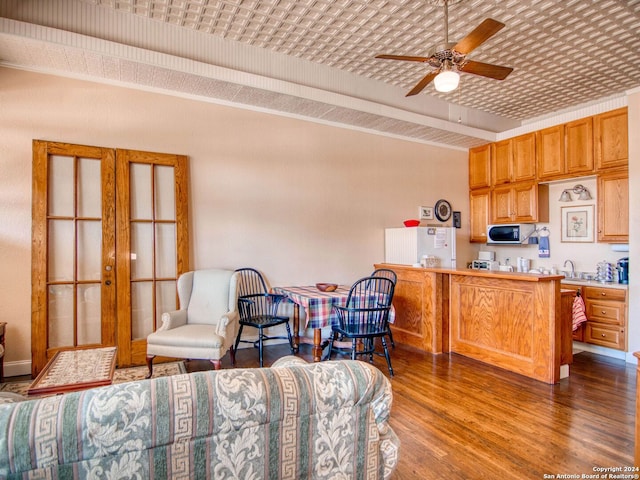 kitchen with ceiling fan, brick ceiling, and dark hardwood / wood-style flooring