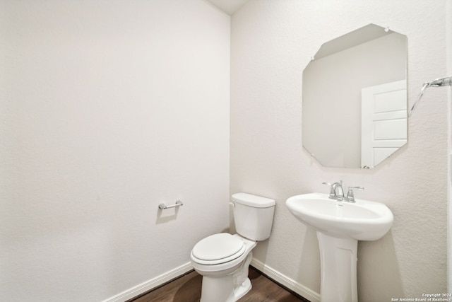 bathroom featuring sink, hardwood / wood-style floors, and toilet