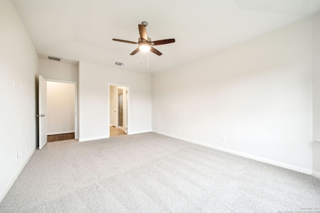 unfurnished bedroom featuring ceiling fan, light colored carpet, and ensuite bathroom