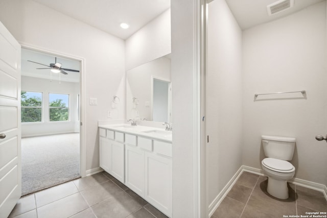 bathroom with tile patterned flooring, vanity, ceiling fan, and toilet