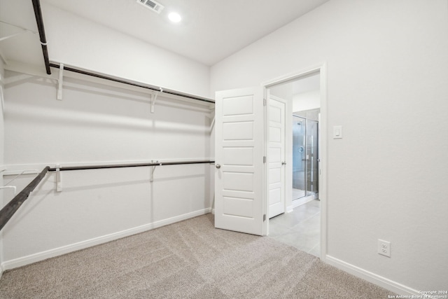 spacious closet featuring light carpet