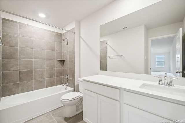 full bathroom featuring tile patterned flooring, vanity, toilet, and tiled shower / bath