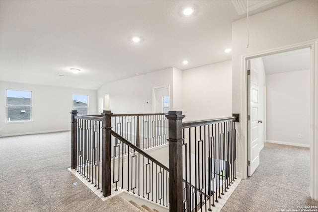 hallway with light colored carpet