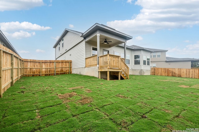 back of property with a lawn and ceiling fan