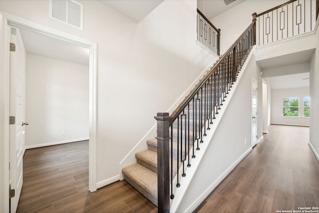 stairway featuring wood-type flooring