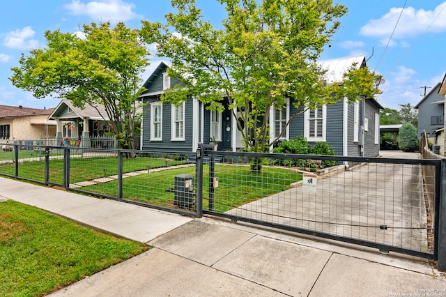 view of property hidden behind natural elements featuring a front yard and central AC unit