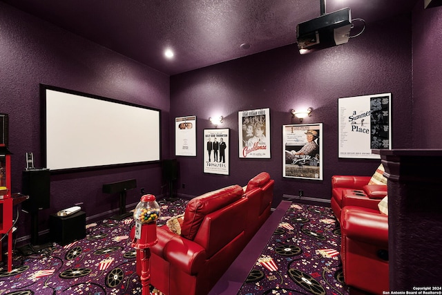 cinema room featuring a textured ceiling and dark colored carpet