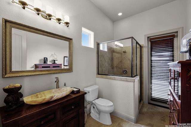 bathroom with a shower with door, vanity, toilet, and tile flooring