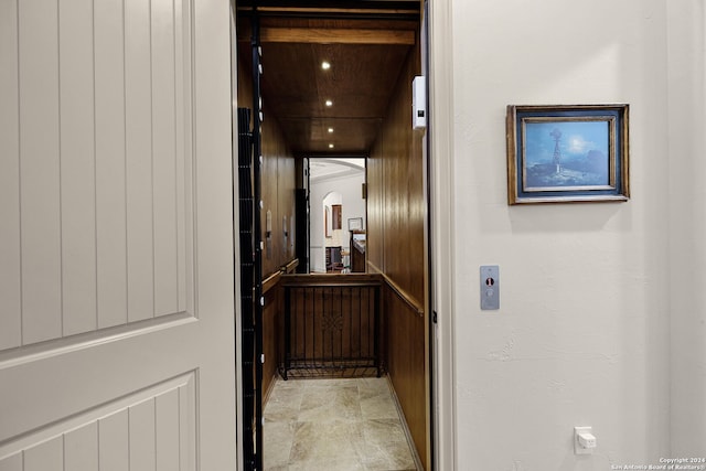 corridor with elevator and light tile floors