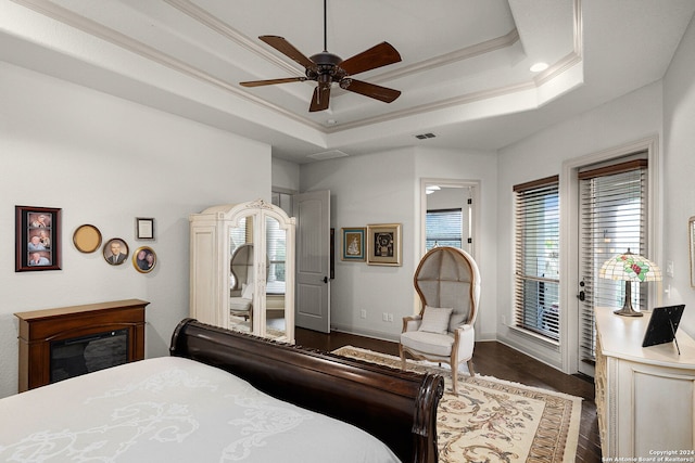 bedroom featuring ceiling fan, dark hardwood / wood-style flooring, access to outside, and multiple windows