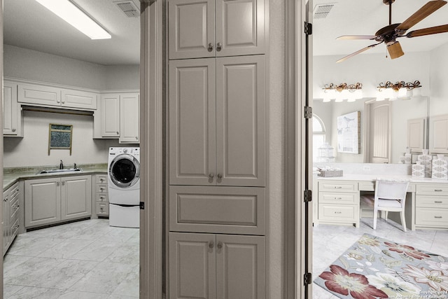 laundry room with cabinets, ceiling fan, washer / dryer, and light tile floors