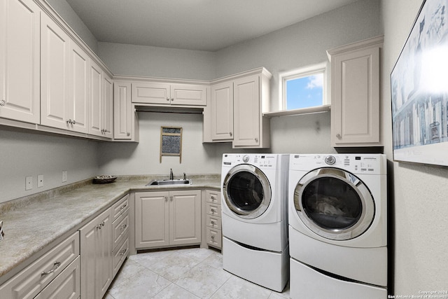 clothes washing area featuring cabinets, sink, independent washer and dryer, and light tile floors