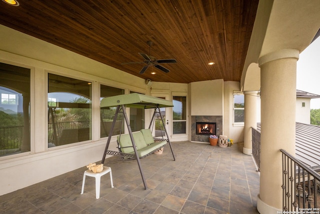 view of patio / terrace with ceiling fan and a premium fireplace