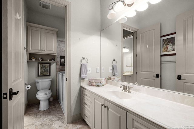 bathroom featuring toilet, tile flooring, and large vanity