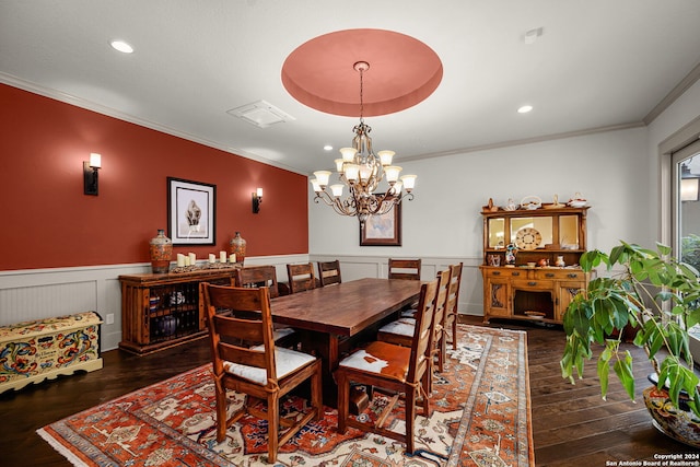 dining space featuring a chandelier, dark hardwood / wood-style floors, and a tray ceiling