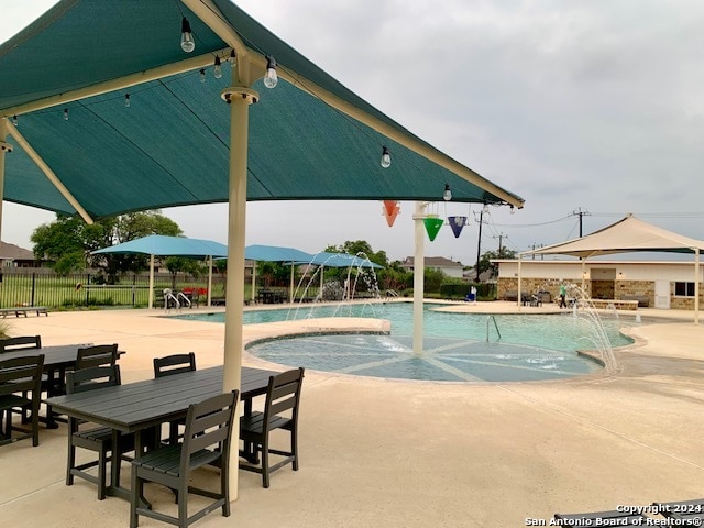 pool with a patio and fence