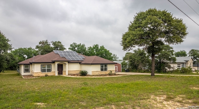 view of front of house with solar panels and a front lawn