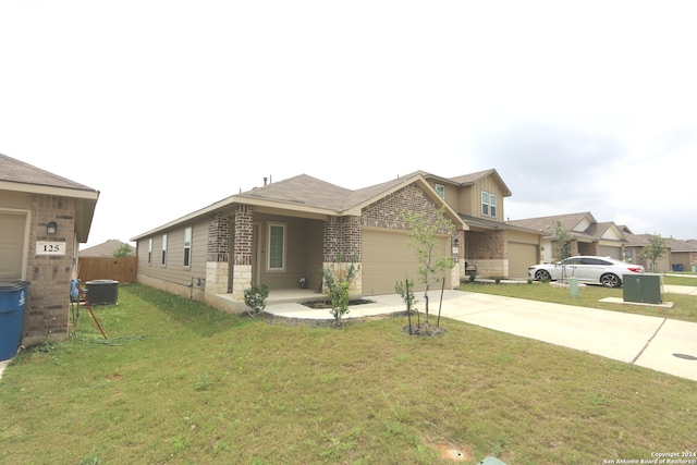 view of front of house with a front lawn, a garage, and central air condition unit