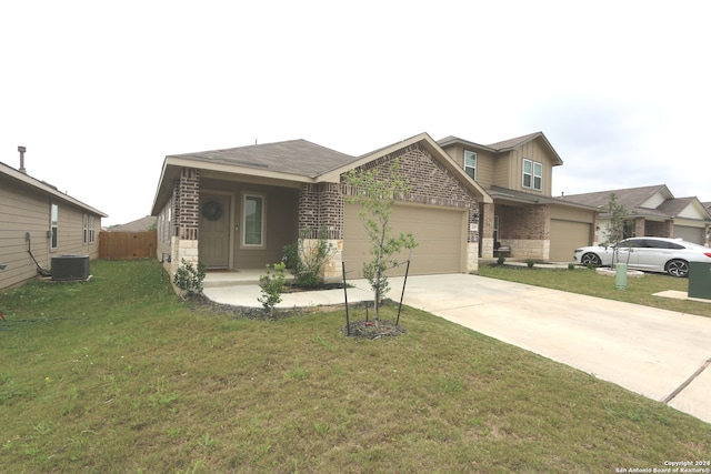 view of front of house featuring central AC, a garage, and a front yard