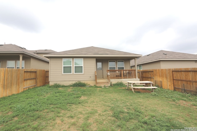 rear view of property with a lawn