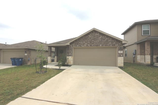 view of front of property with a garage and a front lawn