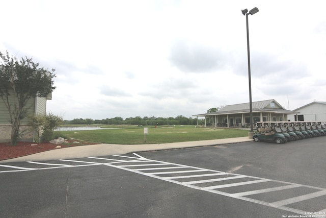 view of car parking featuring a lawn