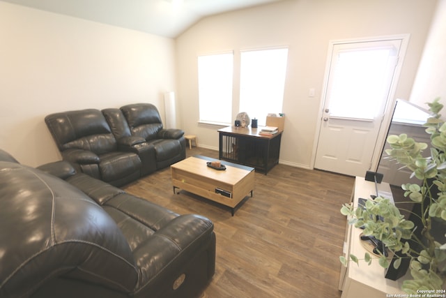 living room with dark wood-type flooring and vaulted ceiling