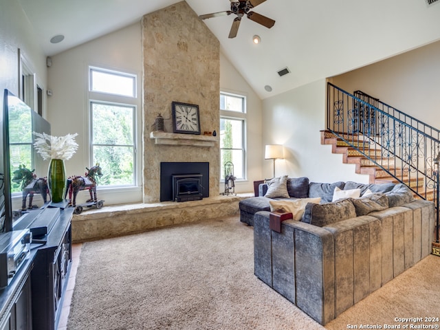 carpeted living room with high vaulted ceiling, ceiling fan, and a fireplace