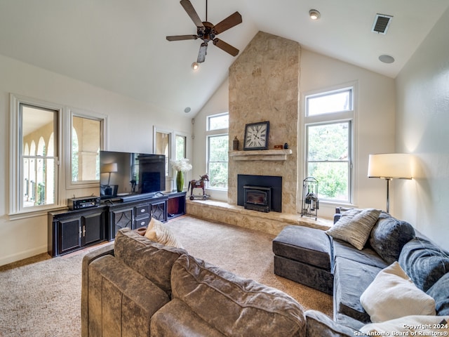 carpeted living room with ceiling fan, high vaulted ceiling, and a large fireplace