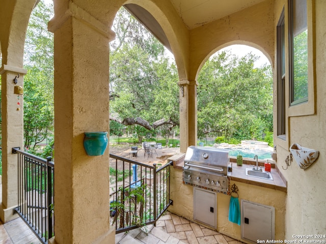 view of patio with area for grilling and exterior kitchen