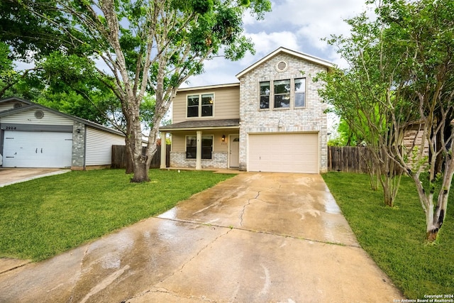 view of property featuring a front yard and a garage