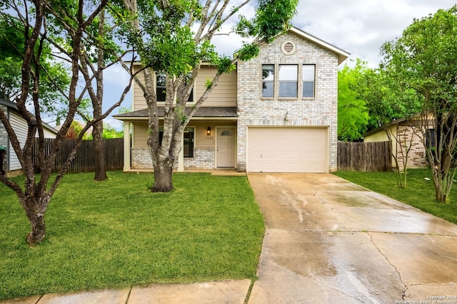 view of front of house with a front yard and a garage