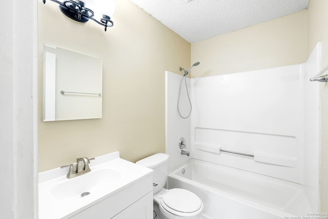 full bathroom with a textured ceiling, toilet, vanity, and bathing tub / shower combination