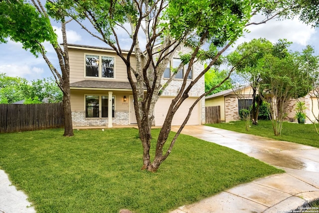 view of front of home with a garage and a front lawn