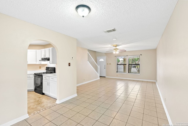 tiled spare room featuring ceiling fan and a textured ceiling