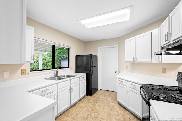 kitchen with white cabinets, sink, black refrigerator, and range with electric stovetop