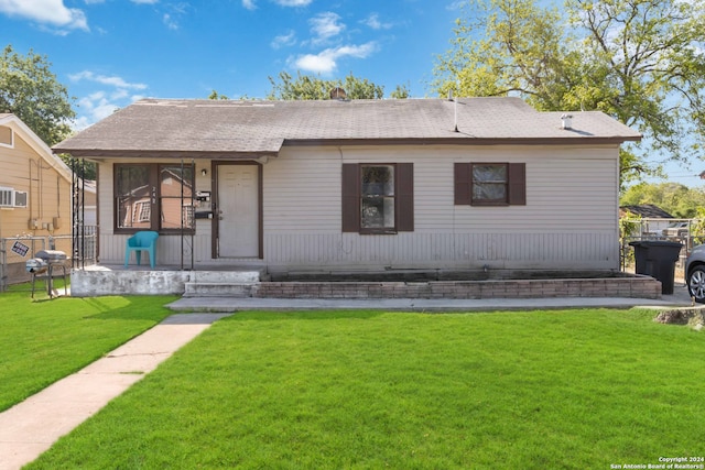 back of property featuring a lawn