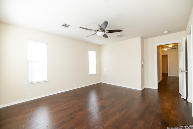 empty room featuring dark hardwood / wood-style flooring and ceiling fan