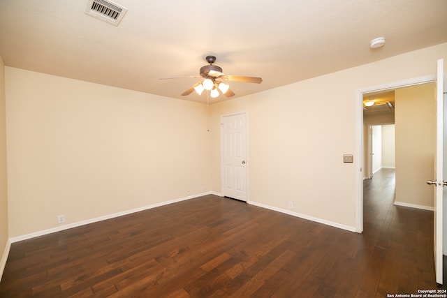 spare room featuring ceiling fan and dark hardwood / wood-style flooring