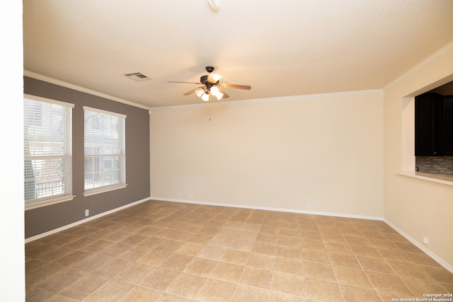 tiled empty room featuring crown molding and ceiling fan