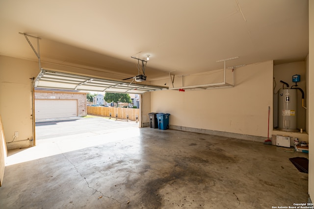 garage with a garage door opener and electric water heater