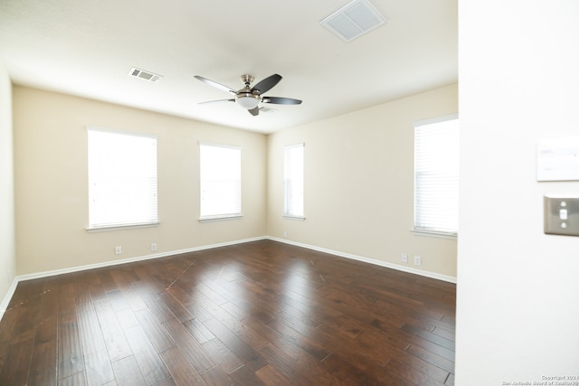 empty room with dark hardwood / wood-style flooring and ceiling fan