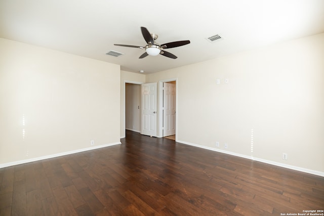 empty room with dark wood-type flooring and ceiling fan