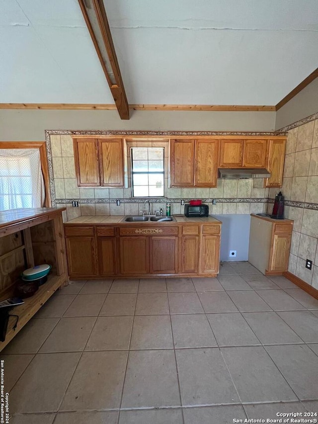 kitchen with sink, backsplash, and light tile floors