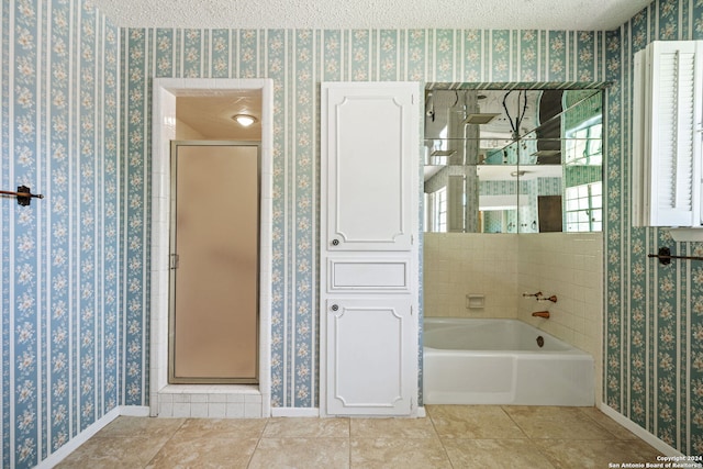 bathroom featuring plus walk in shower, a textured ceiling, and tile patterned floors