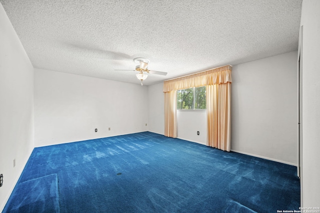 carpeted empty room featuring a textured ceiling and ceiling fan