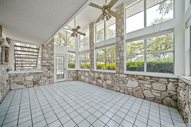 unfurnished sunroom with vaulted ceiling and ceiling fan