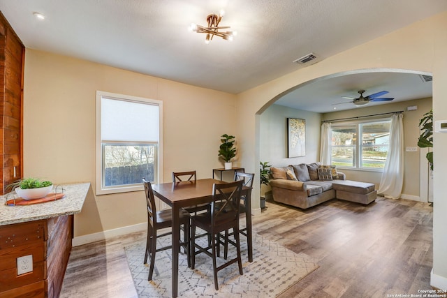 dining space with dark wood-type flooring and ceiling fan