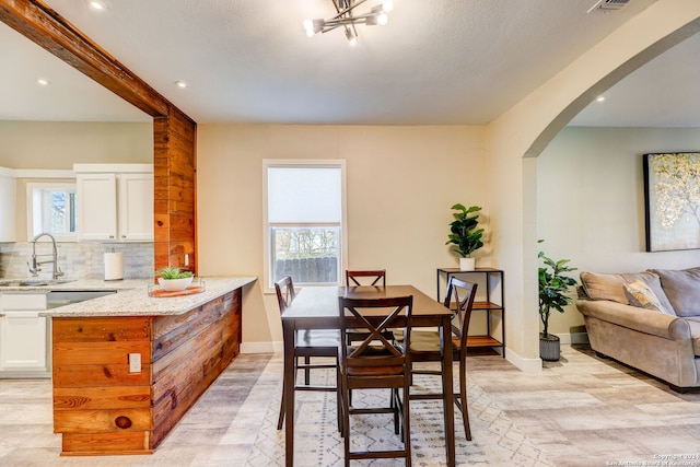 dining area featuring sink and plenty of natural light