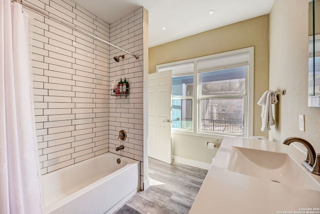 bathroom featuring hardwood / wood-style floors, vanity, and shower / bath combination with curtain